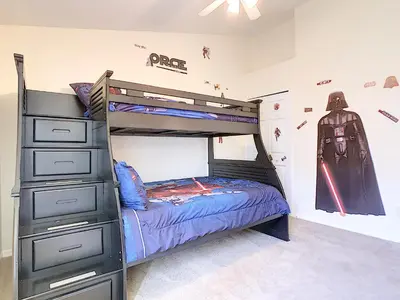 a bedroom with a bunk bed with a batman mural at Cinderellas Castle in Kissimmee