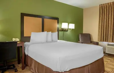 a hotel room with a large bed and a desk at Extended Stay America Suites - Orlando - Orlando Theme Parks - Major Blvd in Orlando