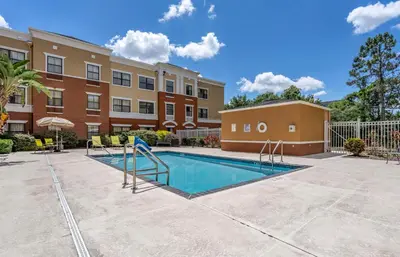 a swimming pool in front of a building at Extended Stay America Suites - Orlando - Maitland - 1776 Pembrook Dr in Orlando