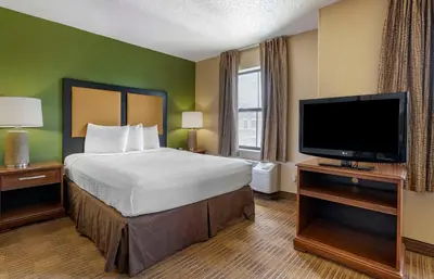 a hotel room with a bed and a flat screen tv at Extended Stay America Suites - Orlando - Maitland - 1776 Pembrook Dr in Orlando
