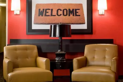 two chairs and a lamp in a waiting room at Extended Stay America Suites - Orlando - Maitland - 1776 Pembrook Dr in Orlando