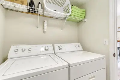 a laundry room with two washing machines and a drying rack at Emerald Delight 3 bed townhome near Disney in Kissimmee