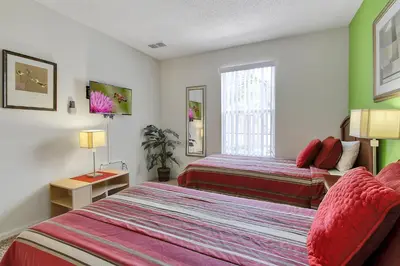 a hotel room with two beds and a window at Emerald Delight 3 bed townhome near Disney in Kissimmee