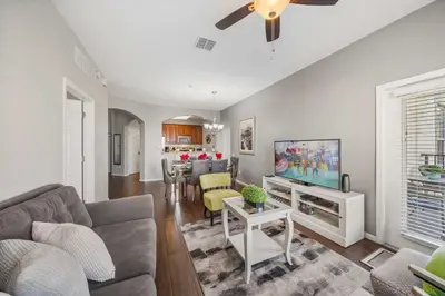 a living room with a couch and a tv at Deluxe 3 Bedroom Apartment 404 in Orlando