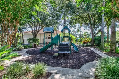a playground with a slide in a park at The Floridian 3 bed townhouse at Emerald Island Resort in Kissimmee