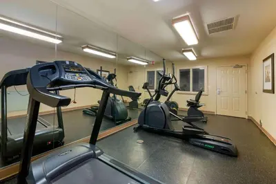 a gym with treadmills and exercise bikes in a room at Extended Stay America Suites - Orlando - Convention Center - 6443 Westwood in Orlando