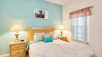 a bedroom with a bed and two lamps and a window at Bikini on the Beach at Terra Verde Resort in Kissimmee