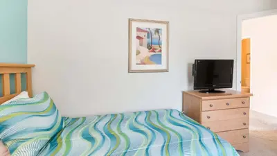a bedroom with a bed and a tv on a dresser at Bikini on the Beach at Terra Verde Resort in Kissimmee