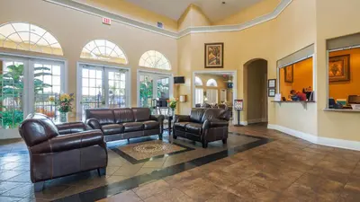 a lobby with leather furniture and windows at Bikini on the Beach at Terra Verde Resort in Kissimmee