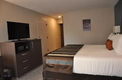 a hotel room with a bed and a flat screen tv at Nobile Hotel Parkway at Celebration Orlando Very Close to Disney Theme Parks in Orlando