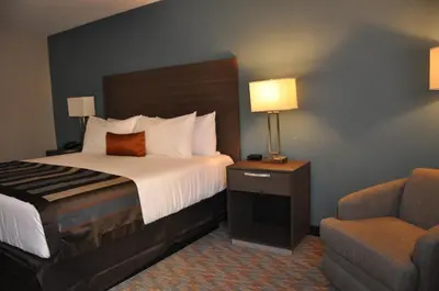 a hotel room with a bed and a chair at Nobile Hotel Parkway at Celebration Orlando Very Close to Disney Theme Parks in Orlando
