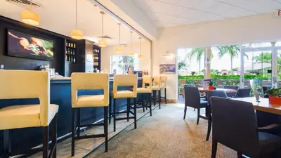 a restaurant with a bar with chairs and tables at Encantada Rose - a 4 bed townhouse near Disney in Kissimmee