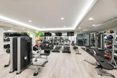 a gym with a lot of treadmills and machines at Siena at Bella Collina in Montverde