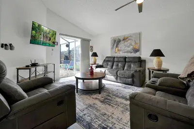 a living room with couches and a table at Bikini Bottom - 4 bed Disney pool home in Kissimmee