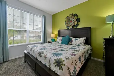 a bedroom with a bed and a window at Castaway Getaway - Very popular 4 bed family pool home on Terra Verde Resort - close to Disney World in Kissimmee