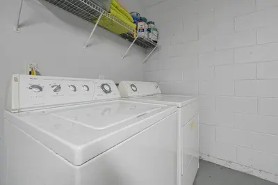 a white washing machine in a white laundry room at Castaway Getaway - Very popular 4 bed family pool home on Terra Verde Resort - close to Disney World in Kissimmee