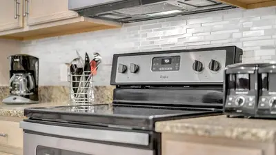 a kitchen with a stove top oven in a kitchen at Disney Backstage Villa - Stay in this popular 4 bed pool home that's very close to Disney in Orlando