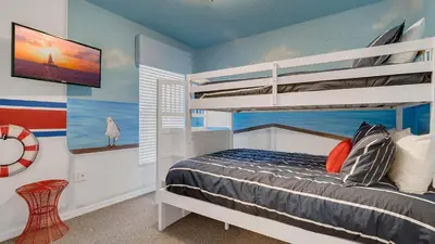 a bedroom with a bunk bed and a tv at Disney Backstage Villa - Stay in this popular 4 bed pool home that's very close to Disney in Orlando