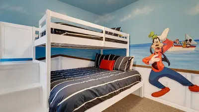 a bedroom with a bed with a mickey mouse mural at Disney Backstage Villa - Stay in this popular 4 bed pool home that's very close to Disney in Orlando