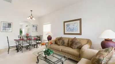 a living room with a couch and a table at Lucky Charm - Budget-friendly 5 bed vacation home, close to Disney World in Kissimmee