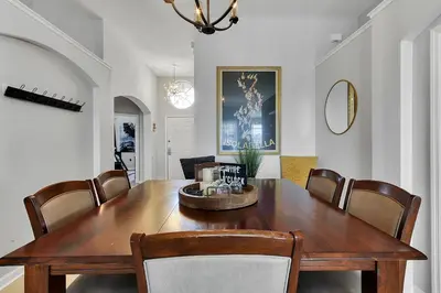 a dining room with a wooden table and chairs at Sunshine Station - Spacious 4 bed Windsor Palms resort home that's close to Disney in Kissimmee