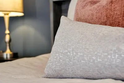 a pillow sitting on top of a bed with a lamp at Sunshine Station - Spacious 4 bed Windsor Palms resort home that's close to Disney in Kissimmee