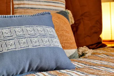 a bed with a pillow and pillows on it at Sunshine Station - Spacious 4 bed Windsor Palms resort home that's close to Disney in Kissimmee