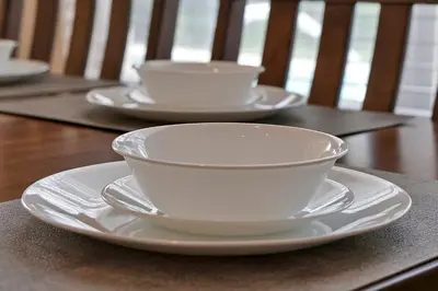 three white cups and saucers on a wooden table at Disney Magic Vacation - A fabulous 4 bed family pool home on Windsor Palms Resort - close to Disney World in Kissimmee