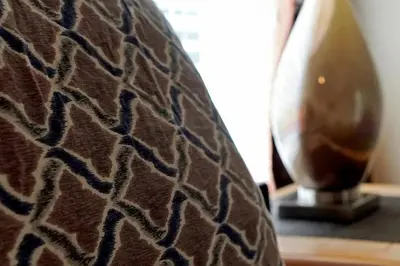 a close up of a couch with a vase on a table at Disney Magic Vacation - A fabulous 4 bed family pool home on Windsor Palms Resort - close to Disney World in Kissimmee