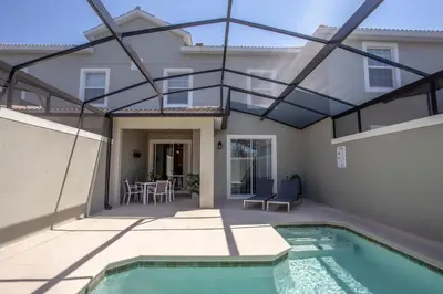 a patio with a swimming pool and a house at Luxurious 4Bd Home w/ Pool 4983 in Kissimmee
