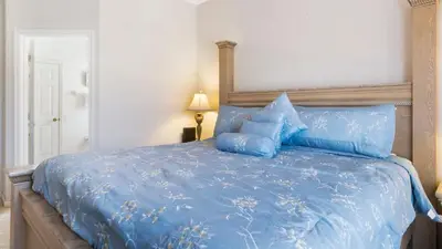 a bedroom with a blue bed with blue pillows at Rhapsody Palms - Family 4-bed pool home that's close to Disney in Kissimmee