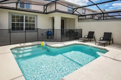 a swimming pool in the backyard of a house at G - New 5 Bedroom Home - 5 Miles to Disney - Free Water Park - Private Pool in Kissimmee