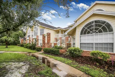 a house with a pathway in front of it at Great Lovely Family Apartment close Disney in Kissimmee