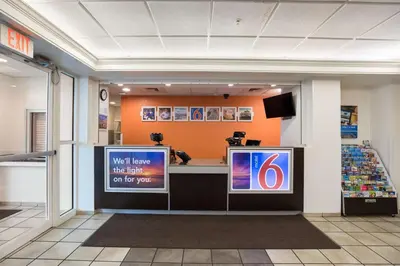 a waiting area in a store with two televisions at Motel 6-Orlando, FL - International Dr in Orlando