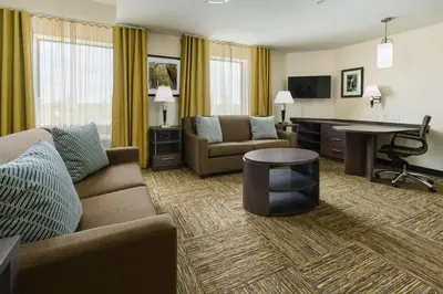 a living room with a couch and a table at Candlewood Suites - Orlando - Lake Buena Vista by IHG in Orlando