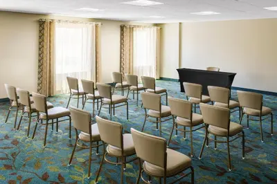 a room with rows of chairs and a piano at Candlewood Suites - Orlando - Lake Buena Vista by IHG in Orlando