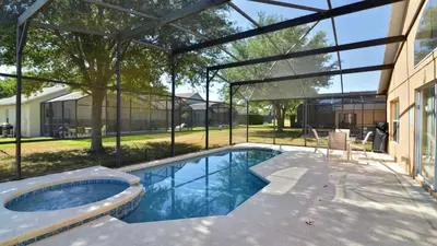a swimming pool with a pergola next to a house at Shooting Star - Family friendly 4 bed pool home on Emerald Island Resort - close to Disney World! in Kissimmee