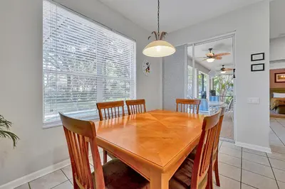 a dining room with a wooden table and chairs at Mickey's Ranch - 4 bed pool home - Windsor Hills in Orlando