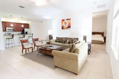 a living room with a couch and a table at 5min Universal Spacious Condo VC101 in Orlando