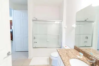 a bathroom with a toilet and a shower and a sink at 5min Universal Spacious Condo VC101 in Orlando