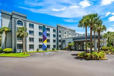 an office building with palm trees in a parking lot at Spark by Hilton Orlando near Universal in Orlando