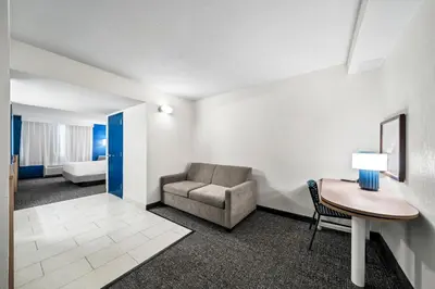 a living room with a chair and a desk at Spark by Hilton Orlando near Universal in Orlando