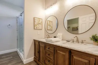 a bathroom with a sink and a mirror at Disney Daze Villa - 5 bed Windsor Hills pool home in Orlando
