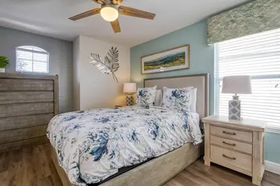 a bedroom with a bed and a ceiling fan at Disney Daze Villa - 5 bed Windsor Hills pool home in Orlando
