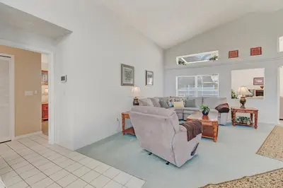 a living room with a couch and a table at Quiet Home With Private Pool- Near Disney in Kissimmee