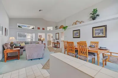 a living room with a table and chairs at Quiet Home With Private Pool- Near Disney in Kissimmee