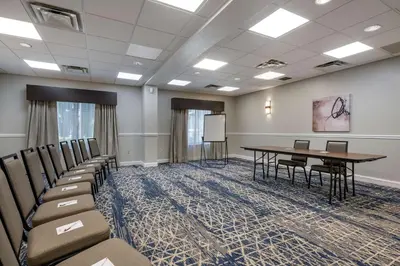 a conference room with a table and chairs at Best Western Plus Orlando East - UCF Area in Orlando