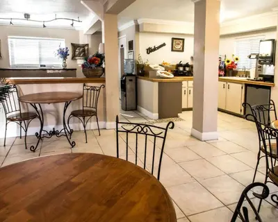 a kitchen with a table and chairs in a room at Rodeway Inn Apopka South in Orlando