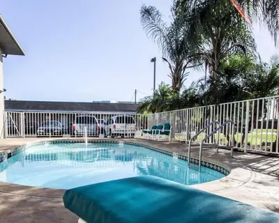 a swimming pool in front of a fence at Rodeway Inn Apopka South in Orlando