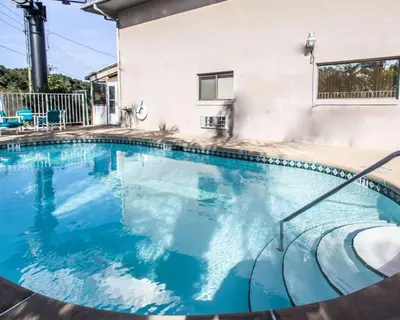 a large swimming pool with blue water at Rodeway Inn Apopka South in Orlando